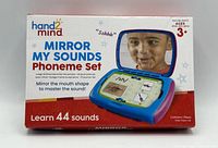 Front of retail box showing product name, image of device, age rating, piece count