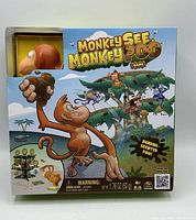 Front of sealed game box showing title, graphics, warning label, net weight