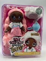 Front view of sealed doll, hat and brush in package