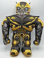 Front view of Bumblebee plush showing printed mechanical graphics