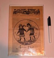 Front cover of 1924 Our Little Ones Canadian Edition magazine beside pen for scale