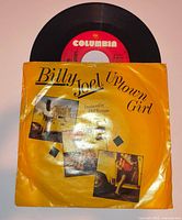 Front view of Billy Joel Uptown Girl 45 RPM vinyl single in yellow picture sleeve