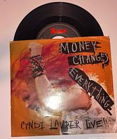 Front view of 7" vinyl record partially inserted in original picture sleeve