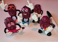 Group shot of all five California Raisins figurines in various poses showing condition and accessories