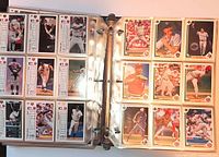 Open binder showing pages of Upper Deck baseball cards front and back