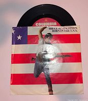 Front view of record partially removed from picture sleeve