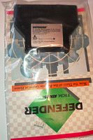 Front view of Defender cartridge and manual in plastic bag