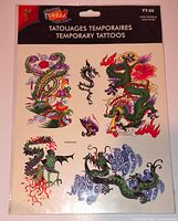Front view of sealed Eureka TT-25 temporary tattoo package showing four dragon designs and branding