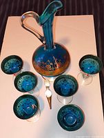 Top view showing decanter with stopper and six goblets