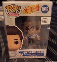 Front view of boxed Funko Pop in protector showing autograph and product details