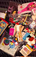 Overview of mixed wood and plastic vintage toys in bags and loose