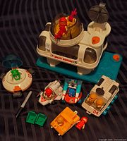 Overview of space station, five vehicles, figures and seats