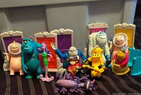 Group shot of all Monsters Inc Happy Meal figures and door pieces