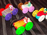Four McDonald’s Tiny Toon Adventures flip cars on striped fabric background