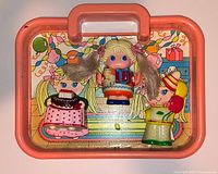 Overview of playset showing carry tray, doll body, two outfits