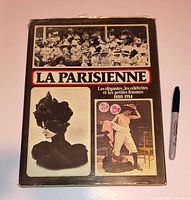 Front view of book with dust jacket and Sharpie for scale