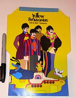 Front view of folded stationery showing Beatles characters and submarine artwork, permanent marker for scale