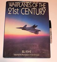 Front cover showing title, author and dust jacket condition with marker for scale