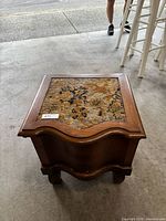 Full view of commode from top showing needlepoint lid