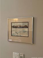 Framed artwork on wall showing full frame and matting