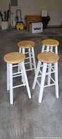 Four wooden bar stools in garage space