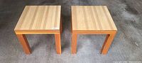 Two square wooden end tables top view