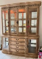 Full frontal view showing upper glass hutch and lower drawer base