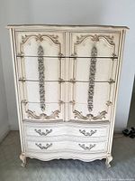 Front view showing carved details and drawers