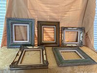 Group shot of all five ornate empty frames on table
