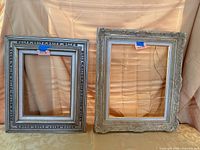 Both empty ornate frames side by side