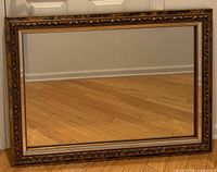 Front view shows full rectangular mirror with ornate gold frame