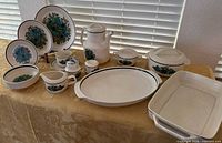 Full set of dinnerware and serveware displayed on table