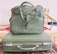 Suitcase with handbag stacked, showing size, color match, chrome latches and logo badges