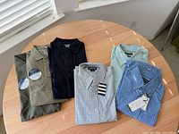 All six folded shirts on tabletop