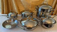 Full 12-piece stainless cookware set laid out