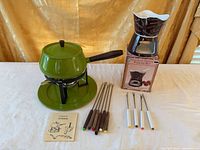 both fondue sets with forks, booklet and packaging