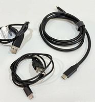 Three loose cables laid out: USB-C to USB-C, two USB-A to Micro-USB