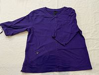 Front view of purple tunic showing pockets and sleeves