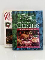 Front covers of both hardcover Christmas cookbooks