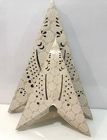 Star folded flat to show pattern and cut-outs