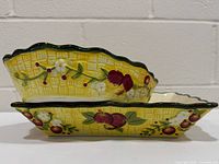 side view of stacked round and square dishes showing exterior pattern and scalloped rims