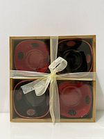 Top view of four bowls in wooden box tied with ribbon