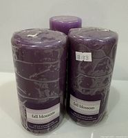 Three wrapped purple Fall Blossom candles front view