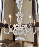 chandelier lit with bulbs installed, showing full form and six twisted arms