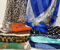Stack of assorted scarves showing variety of patterns and colours