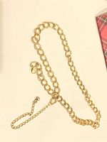 Gold-tone double loop chain necklace laid out showing links, clasp and extender