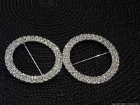 Front view of both rhinestone circle brooches showing sparkle and design