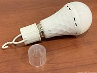 Bulb, hook cap, and clear cap on tabletop