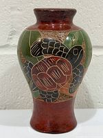 Front view showing full vase and turtle motif