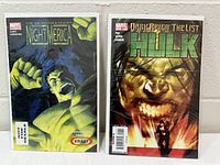 Both bagged Hulk comic books side by side